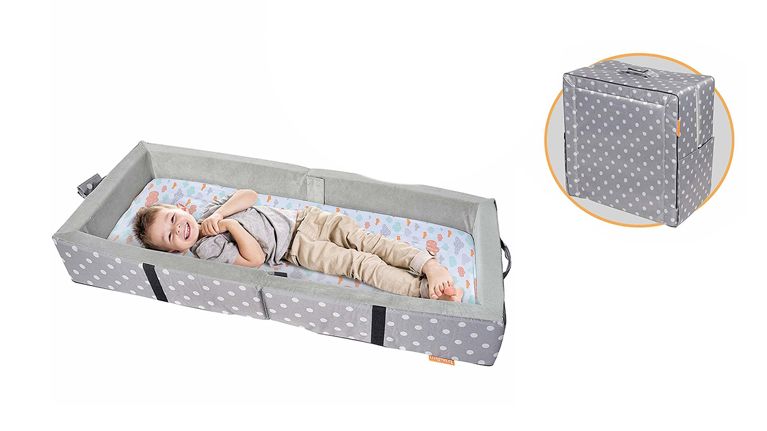 Little boy laying in a portable bed