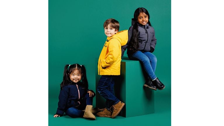 three kids wearing car seat-safe jackets