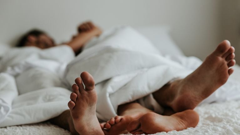 Feet of a couple in a bed