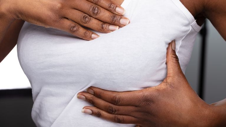 Close-up Of A Woman's Hand On Breast 