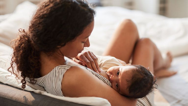 Young Mother Breastfeeding Baby Baby at Home