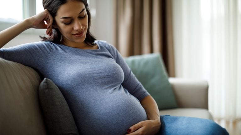 Portrait of young happy pregnant woman