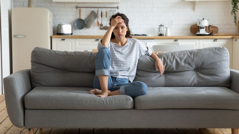 Tired upset woman worried about tiredness from domestic work.