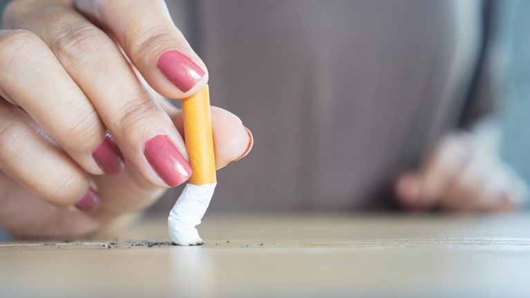 closeup woman hand destroying cigarette stop smoking concept