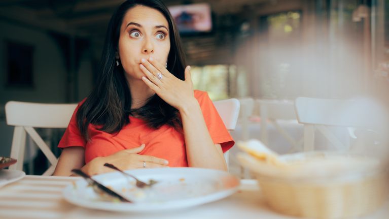 Funny Woman Feeling Full after Eating a Large portion of Food