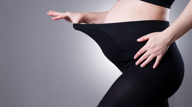 Pregnant woman in black tights for pregnant women