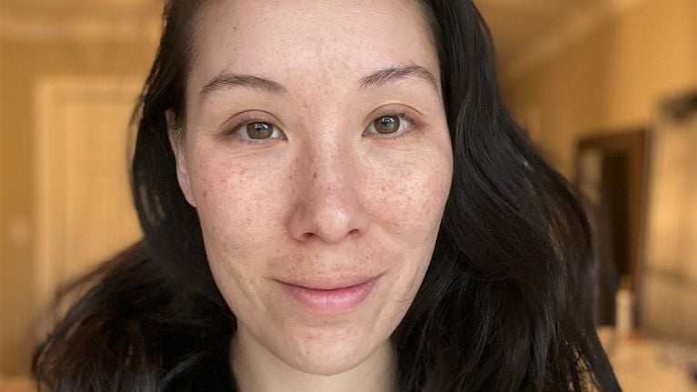 A close-up of a woman's face before getting DIY lash extensions.