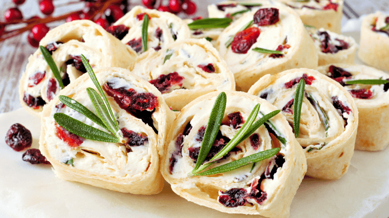 plate of cream cheese pinwheels with cranberries and rosemary