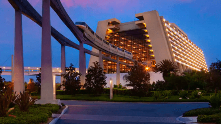 photo of the disney contemporary resort at night with the monorail going through