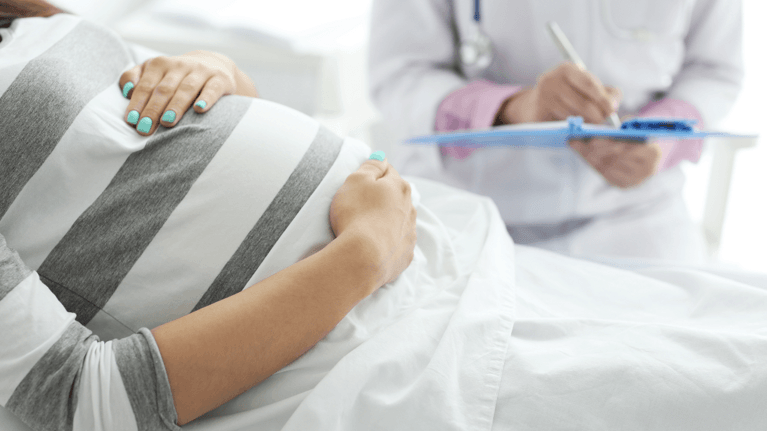 pregnant woman being examined at the doctors