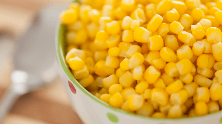 bowl of corn sitting on a table