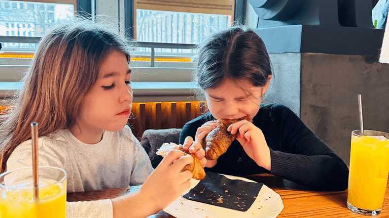 author Kyla's daughters eating croissants
