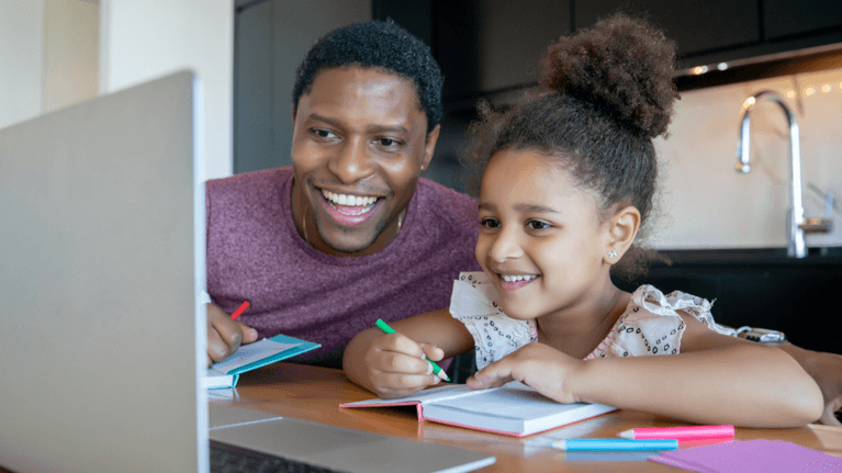 parent helping a child on the computer with school work