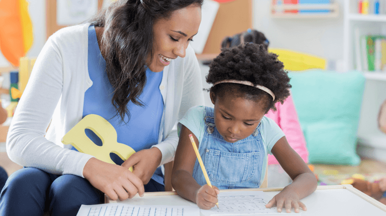 teacher helping a student with homework